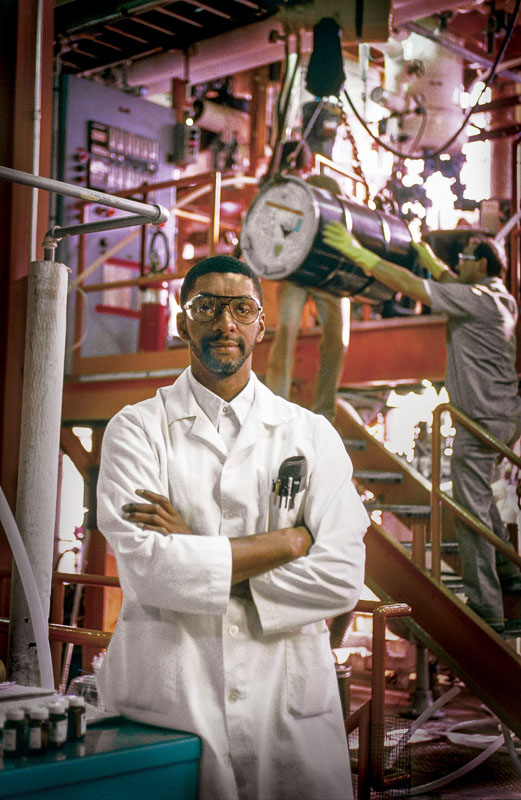 Image shows Portrait of industrial worker in chemical plant facility created for annual report by Raleigh, Durham, Chapel Hill Photographer Bruce Johnson Studios